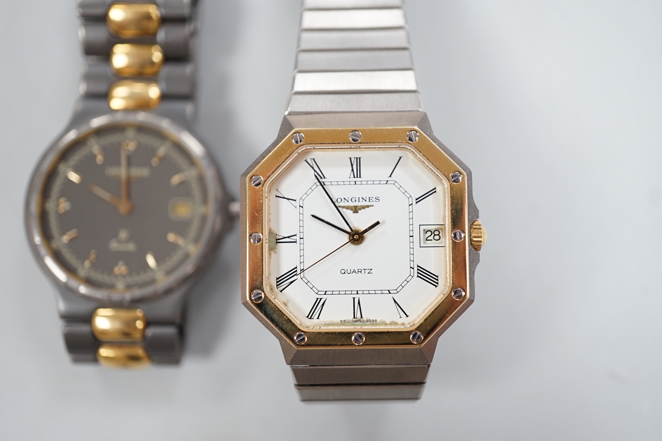 Two gentleman's steel and gold plated Longines quartz wrist watches, one with octagonal case.